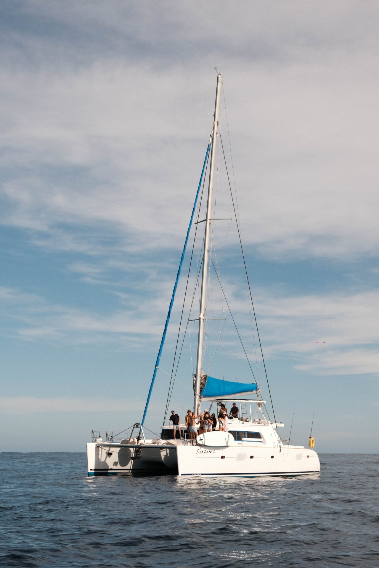 Private catamaran deck with guests enjoying a calm day on the Sea of Cortez